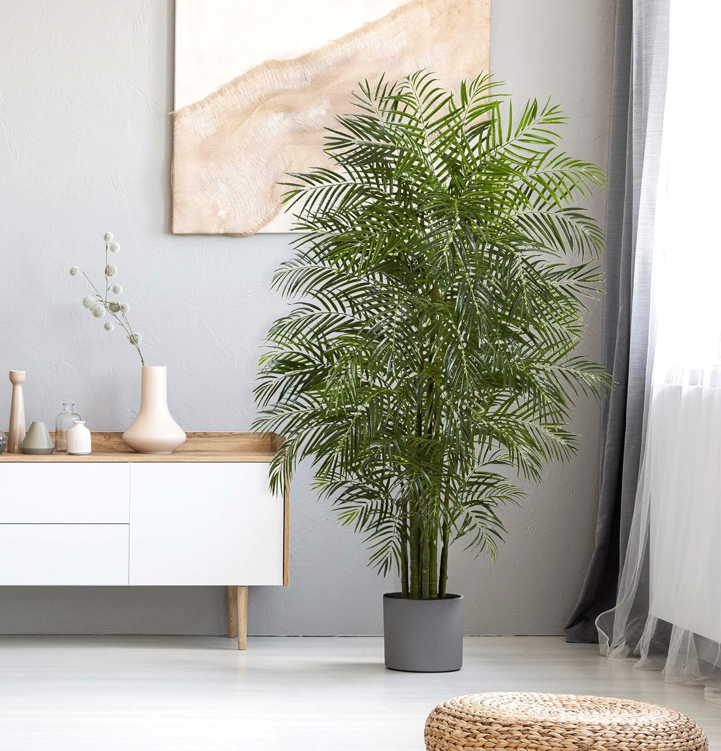 A cozy living room corner with an Areca Artificial Palm Tree, adding vibrant greenery for a tropical, low-maintenance decor touch
